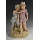 A Heubach bisque porcelain figure group, At the Seaside, moulded with two children,