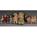 A Kestner all bisque doll`s house doll, with brown eyes, closed mouth, brown wig, jointed limbs,