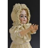 A Kestner bisque head doll, German 1890, with open blue eyes, painted eye lashes and eye brows,