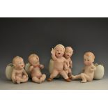A set of four Gebruder Heubach bisque piano babies, in various poses, naked,