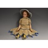 An Armand Marseille dolls house doll, with sleeping blue eyes, short brown hair, composite body,