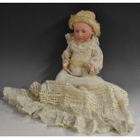 A Gebruder Heubach bisque head baby doll, open blue eyes, closed mouth, moulded hair,