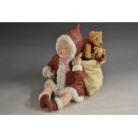 A Gebruder Heubach bisque piano baby, dressed in Santa Claus outfit with a sack of toys, 18cm,