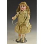 A German bisque doll, circa 1910, sleeping brown glass eyes, painted eye lashes and brows,