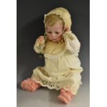 A Kammer & Reinhardt bisque head baby doll, with sleeping blue glass eyes, slightly open mouth,