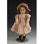 A Simon and Halbig bisque head doll, German 1870, with open blue eyes, feathered brows,