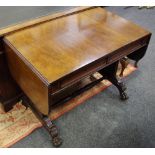 A mahogany sofa table, cross banded top, two short drawers to frieze, carved end supports,