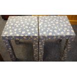 A pair of retro bedside tables covered in autumn leaf fabric,