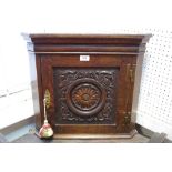 A small late 19th/early 20th century carved oak corner cupboard