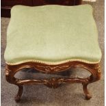 A walnut footstool, stuffed serpentine rectangular seat, French cabriole legs,