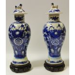 A pair of 19th century Chinese baluster shaped vases decorated with nesting birds amongst foliage,