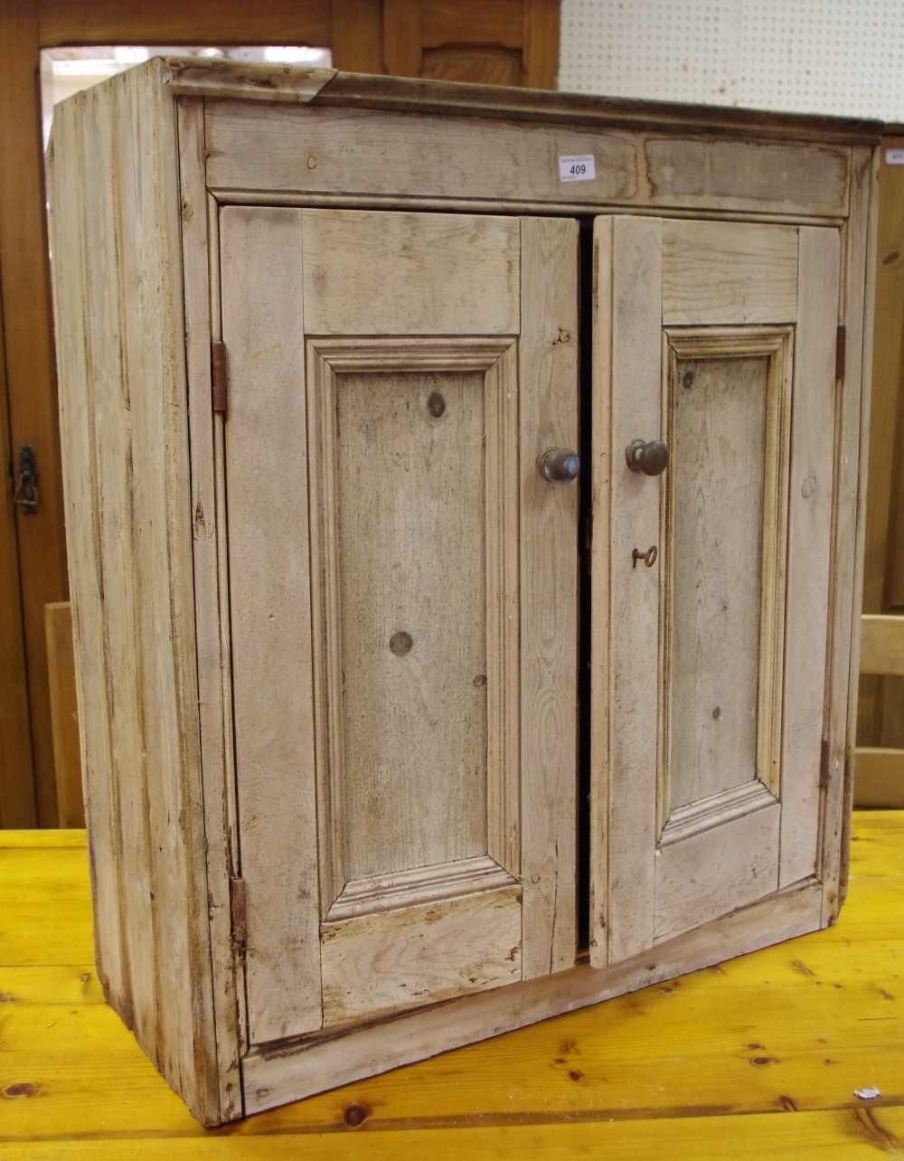 A Victorian rustic pine side cupboard, two panel doors enclosing shelving,