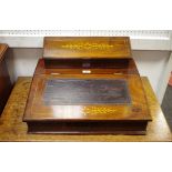 A mahogany writing slope hinged sloping lid to pen tray, leather inlaid writing surface,