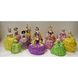 Twelve Continental porcelain elegant lady figural dressing table jar and covers in various poses