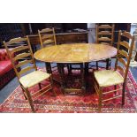 A barleytwist oak gateleg table, oval top; four ladderback chairs, raffia seats.