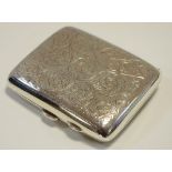 An early 20th century silver cigarette case engraved with foliate scrolls