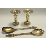 A pair of silver salad servers, the hafts pierced with harebells and foliage,