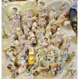 A large quantity of late 19th/early 20th century Continental porcelain figures and figural spill