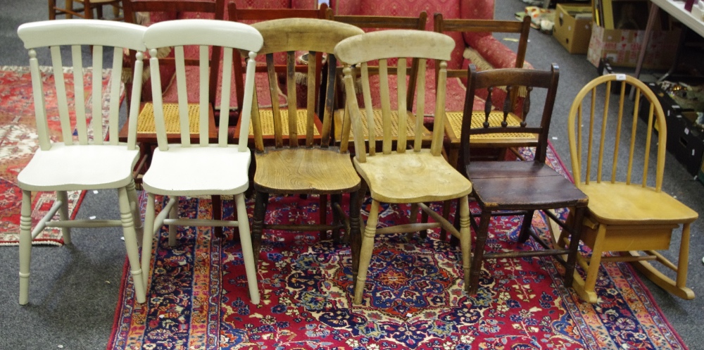 Four lath back kitchen chairs; an Ercol hoop back child's rocking chair with underseat drawer;