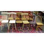 Four lath back kitchen chairs; an Ercol hoop back child's rocking chair with underseat drawer;