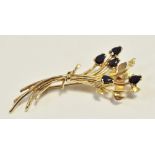 A 9ct gold brooch in the form of a tied bouquet of flowers,