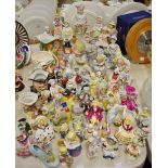 A large quantity of late 19th/early 20th century Continental porcelain figures and figural spill