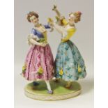A 19th century Dresden figural group of dancers, raised on a plinth base picked out in gilt,
