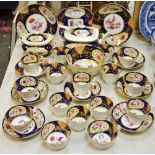 A 19th century boat shaped tea service, decorated with peonies and flowers, yellow borders,