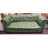 A green leather Chesterfield three seat settee.
