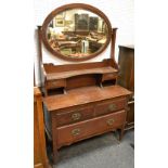 A mahogany dressing chest, oval mirror, shelf and two drawers to superstructure,