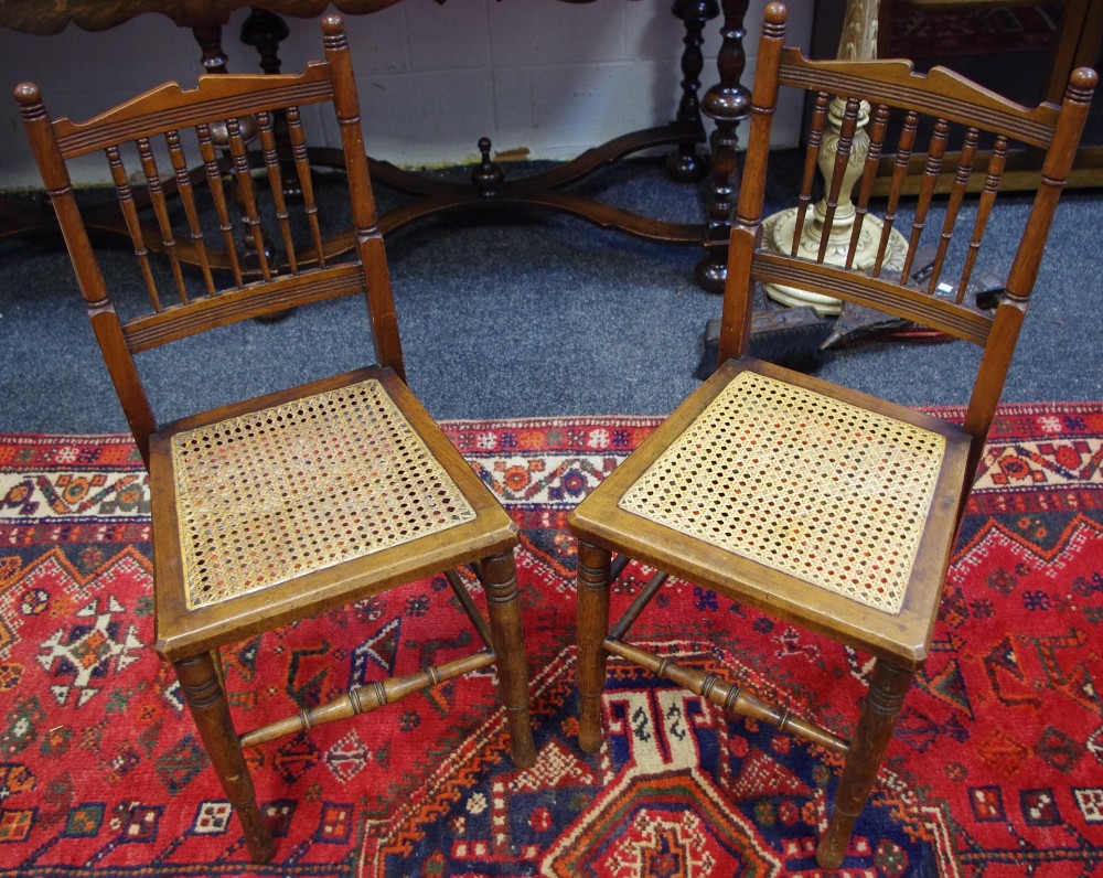 A pair of late Victorian hall chairs, spindle back, cane work seat,