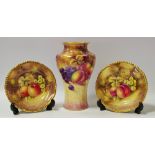 A Royal Worcester baluster shaped vase painted with peaches and grapes on a mossy ground, signed J.