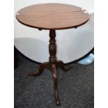 A George III oak tripod occasional table, circular tilting top, ring turned column, triform base,