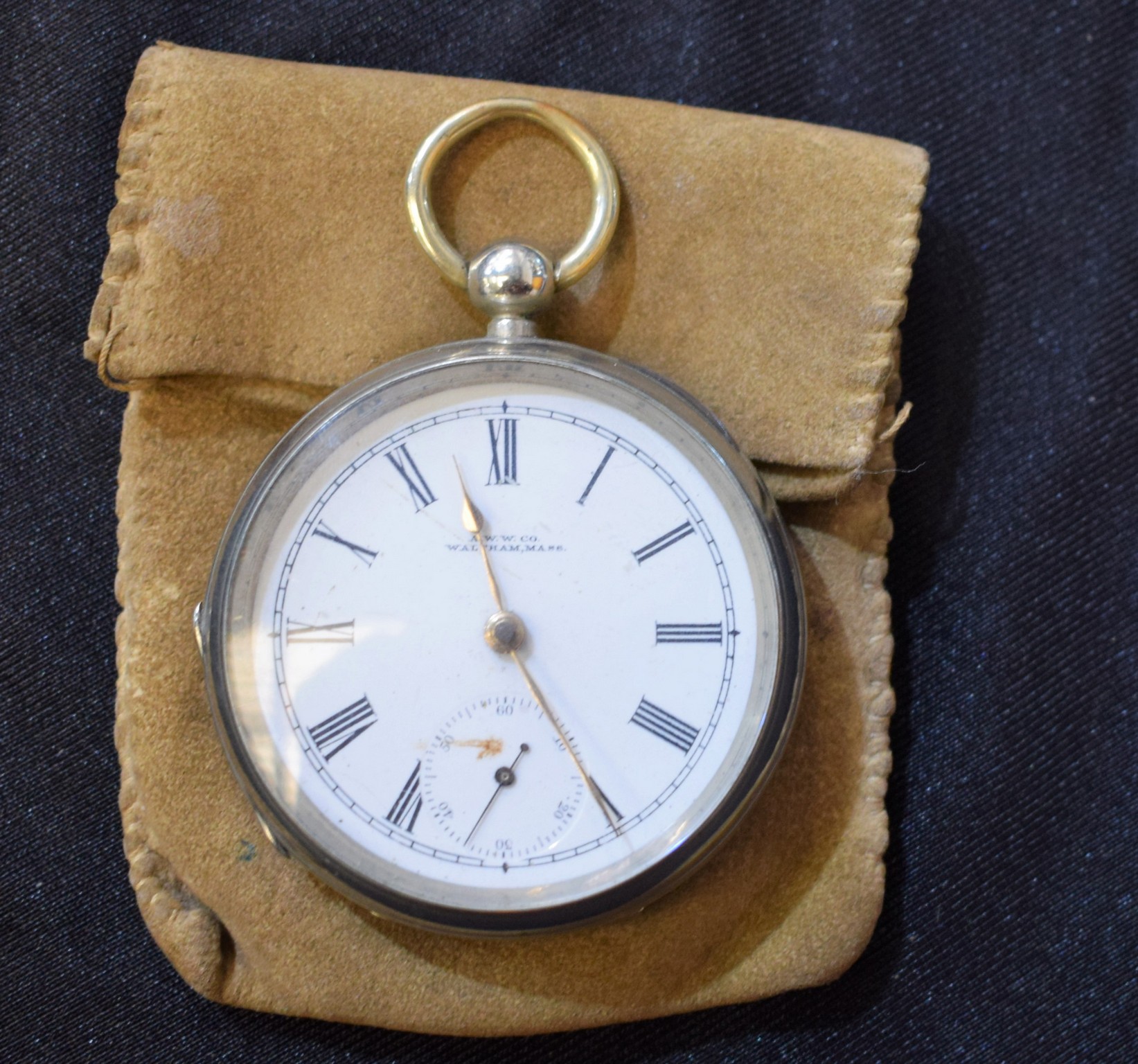 A Continental open face Waltham pocket watch, white enamel dial, Roman numerals, minute track,