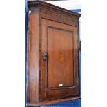 A George III oak corner cupboard,