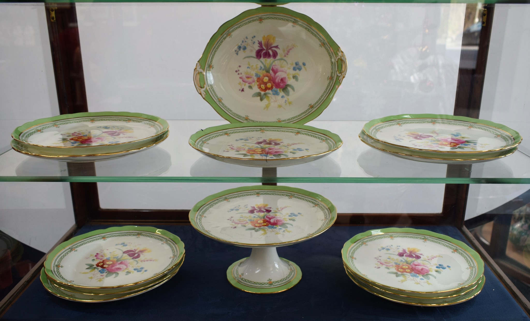 A Cauldon dessert service comprising pedestal comport, lozenge shaped dish, fluted cake plates,