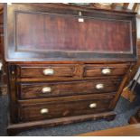 An early 20th century bureau, fall front enclosing a writing surface, small drawer and pigeon holes,