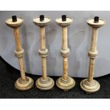 A set of four large ash ecclesiastical candlesticks,