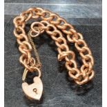 A 9ct rose gold curb bracelet with heart padlock, approx 9.