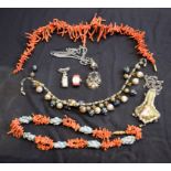 A graduated coral necklace; another coral and jadeite necklace;