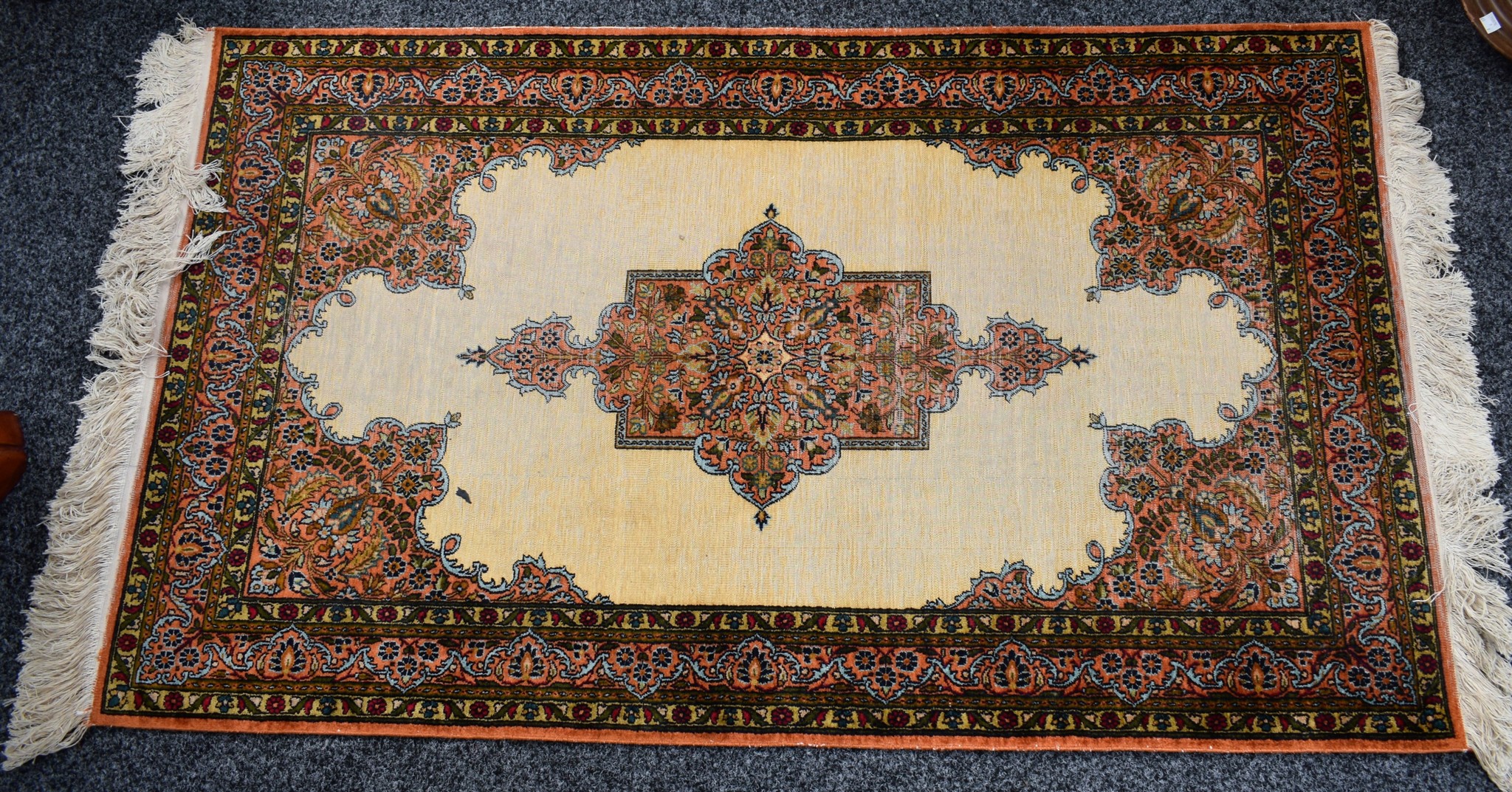 A silk handwoven rug, cream ground, peach,
