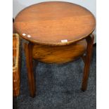 A mid-20th century oak circular two-tier occasional table, 64.