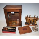 An oak smokers cabinet, glazed door; assorted pipes, including Barling with silver mount,