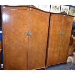 An early-mid 20th century 'walnut' bedroom suite comprising two wardrobes,