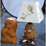 A carved wooden table lamp,