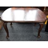 A Queen Anne style dining table, moulded discorectangular top, cabriole legs, pad feet,