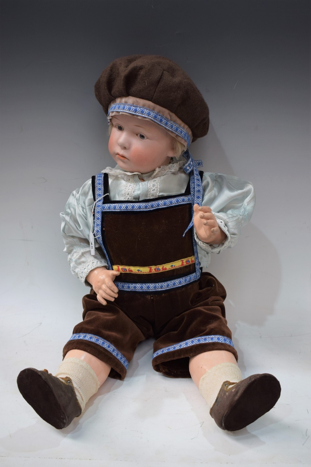 A Gebruder Heubach bisque head pouty character boy doll, with open eyes, closed mouth, blond wig,