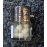 An Edwardian silver mounted smelling salts bottle, hinged planished cover enclosing a stopper,