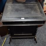 A late Victorian ebonised Davenport desk,