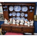 A large George III design oak dresser, open plate rack flanked by cupboards,